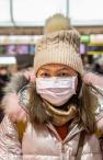 Girl at the airport wearing a mask