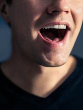 A man using his larynx, and probably his language