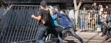 youth tearing down a barricade