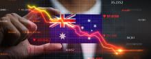 hand holding australian flag with downward trending arrows