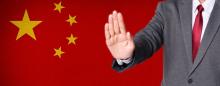 chinese flag with a man holding out hand in rejection