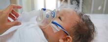 infant with an oxygen mask